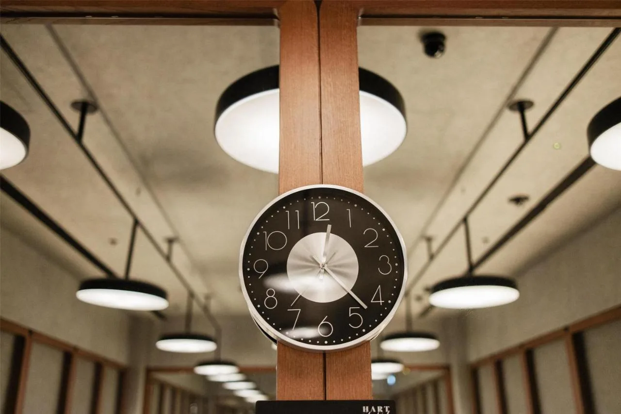 a clock on a pole in a room with lights at Hart Shoreditch Hotel London, Curio Collection by Hilton in London