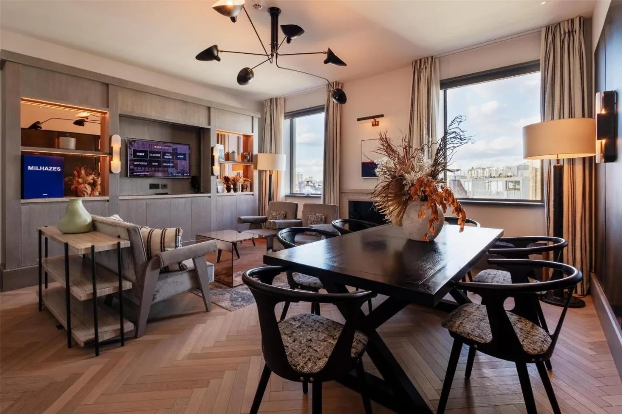 a dining room and living room with a table and chairs at Hart Shoreditch Hotel London, Curio Collection by Hilton in London